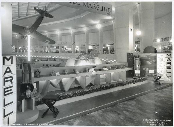 Fiera di Milano - Salone internazionale aeronautico 1937 - Settore accessori, strumenti e materie prime lavorate e semilavorate - Stand di generatori e convertitori per radio della Ercole Marelli