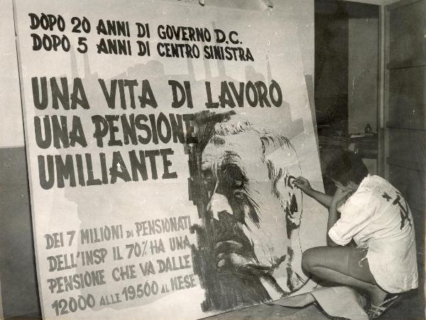 Milano - Festa nazionale de l'Unità 1967 - Un giovane disegna su un cartellone - Scritte