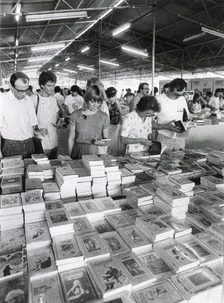 Milano - Festa provinciale de l'Unità 1984 - Monte Stella - Libreria - Visitatori sfogliano dei volumi - Strutture metalliche - Illuminazione