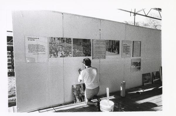 Milano - Festa provinciale de l'Unità 1985 - Monte Stella - Allestimento della mostra dedicata al 40° della Liberazione - Esposizione di pannelli esplicativi - Operaio al lavoro - Scritte