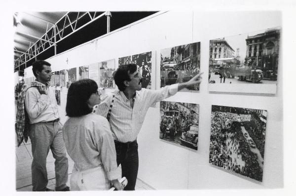 Milano - Festa provinciale de l'Unità 1985 - Monte Stella - Stand "l'Unità" - Mostra dedicata al 40° anniversario della Resistenza - Un visitatore indica un'immagine esposta - Strutture metalliche