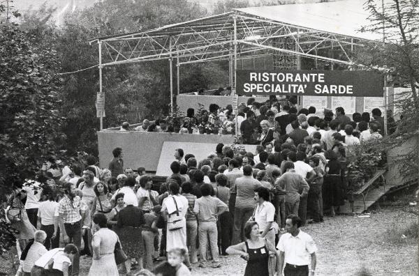 Milano - Festa provinciale de l'Unità 1980 - Monte Stella - Ristorante sardo - Folla in coda in attesa di entrare - Strutture metalliche - Cartello