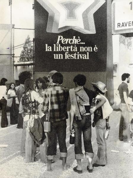 Ravenna - Festa provinciale de l'Unità 1977 - Un gruppo di giovani sosta davanti all'ingresso - Cartello con scritta - Strutture metalliche