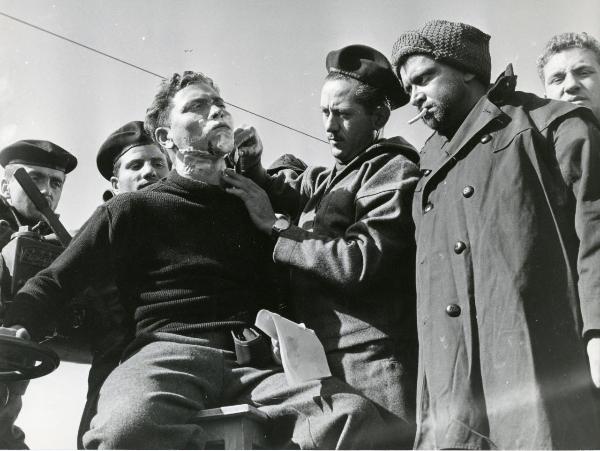 Scena del film "La grande speranza" - Coletti, Duilio, 1954 - Alcuni attori non identificati guardano un attore non identificato che fa la barba a un altro attore non identificato.





