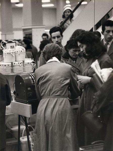 Milano - Upim - Grandi magazzini - Interno - Donne e uomini in coda alla cassa - Commessa - Merce