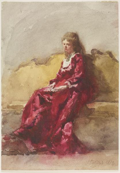 Donna in abito rosso seduta su un divano